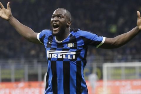 Inter Milan's Romelu Lukaku celebrates after his teammate Roberto Gagliardini scored his side's second goal during a Serie A soccer match between Inter Milan and Genoa, at the San Siro stadium in Milan, Italy, Saturday, Dec. 21, 2019. (AP Photo/Luca Bruno)