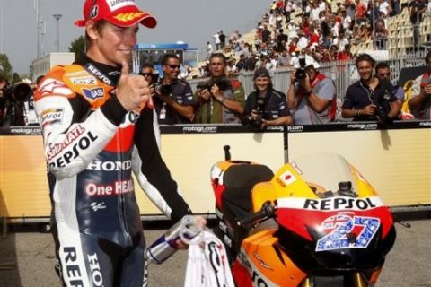 Honda rider Casey Stoner, of Australia, reacts after clocking the fastest time in the qualifying practice session of the San Marino MotoGP grand prix at the Misano circuit, in Misano Adriatico, Italy, Saturday, Sept. 3, 2011. (AP Photo/Antonio Calanni)