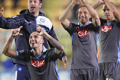 Napoli's  Paolo Cannavaro, left, Gianluca Grava, center, Gokhan Inler from Switzerland , right , celebrates on the end their group A Champions League soccer match at the Madrigal against Villarreal stadium in Villarreal, Spain, Wednesday, Dec. 7, 2011. Napoli qualified for the next round (AP Photo/Alberto Saiz)