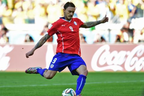 Chile's forward Mauricio Pinilla kicks the ball during the penalty shoot out after extra-time in the Round of 16 football match between Brazil and Chile at The Mineirao Stadium in Belo Horizonte during the 2014 FIFA World Cup on June 28, 2014.   AFP PHOTO / MARTIN BERNETTI        (Photo credit should read MARTIN BERNETTI/AFP/Getty Images)