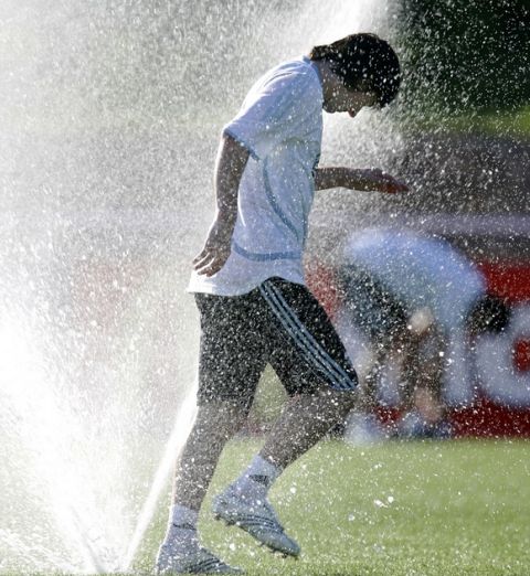 Argentina's national soccer team's player Lionel Messi cool off during a training session in  Herzogs Park training  camp in Herzogenaurach, southern Germany, Sunday, June 11, 2006.  Argentina won their first game against Ivory Coast by 2-1 in Group C at the Soccer World Cup in Germany 2006. Other tems in the group are The Netherlands and Serbia and Montenegro. (AP Photo/Roberto Candia)