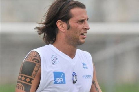 In this picture taken Wednesday, Aug. 3, 2011, Atalanta's captain Cristiano Doni looks on at the end of a friendly soccer match against Lumezzane in Rovetta, Italy. Atalanta will start the Serie A season with a six-point penalty for its role in the latest Italian match-fixing scandal, while its captain Cristiano Doni has been banned for three and a half years. The Italian football federation's disciplinary committee issued the verdicts Tuesday, Aug. 9, 2011, after a lengthy investigation. (AP Photo/Daniele Montigiani, LaPresse) ITALY OUT