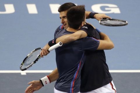 Novak Djokovic of Serbia, right, hugs his brother Djordje after their men's doubles match against Vasek Pospisil of Canada and Jack Sock of the United States in the China Open tennis tournament at the National Tennis Stadium in Beijing, Thursday, Oct. 8, 2015. (AP Photo/Andy Wong)