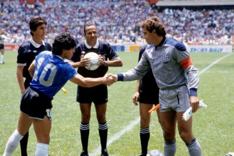 Argentina captain Diego Maradona (l) shakes hands with England captain Peter Shilton (r) as referee Ali Bennaceur (c) checks the match ball is fully inflated and linesman Morera Berny Ulloa (far l) looks on