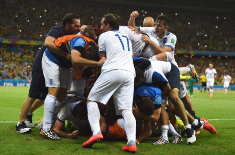 FORTALEZA, BRAZIL - JUNE 24:  Giorgos Samaras of Greece is mobbed by team mates after scoring his team's second goal from the penalty spot during the 2014 FIFA World Cup Brazil Group C match between Greece and Cote D'Ivoire at Estadio Castelao on June 24, 2014 in Fortaleza, Brazil.  (Photo by Lars Baron - FIFA/FIFA via Getty Images)