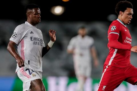 Liverpool's Thiago, right, runs with the ball during the Champions League quarterfinal first leg, soccer match between Real Madrid and Liverpool at the Alfredo di Stefano stadium in Madrid, Spain, Tuesday, April 6, 2021. (AP Photo/Manu Fernandez)