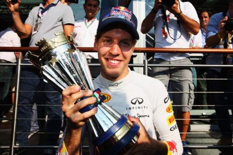 MONZA, ITALY - SEPTEMBER 11:  Sebastian Vettel of Germany and Red Bull Racing celebrates with the winning drivers trophy following the Italian Formula One Grand Prix at the Autodromo Nazionale di Monza on September 11, 2011 in Monza, Italy.  (Photo by Mark Thompson/Getty Images)