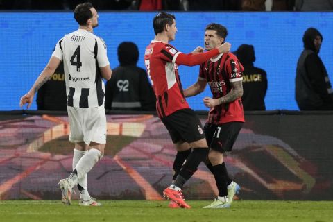 AC Milan's Alvaro Morata, left, and Christian Pulisic celebrate after scoring during the Italian Super Cup semifinal soccer match between Juventus and Milan in Riyadh, Saudi Arabia, Friday, Jan. 3, 2025. (AP Photo/Altaf Qadri)