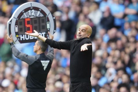 Manchester City's head coach Pep Guardiola gestures during the English Premier League soccer match between Manchester City and Nottingham Forest at Etihad stadium in Manchester, England, Saturday, Sept. 23, 2023. (AP Photo/Jon Super)