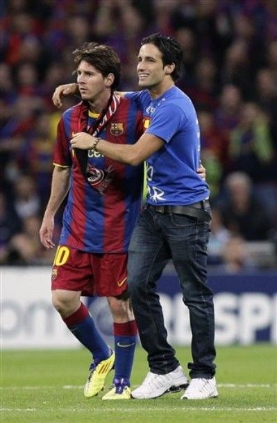 Barcelona's Lionel Messi, left, is seen with a pitch intruder during their Champions League final soccer match against Manchester United at Wembley Stadium, London, Saturday, May 28, 2011. (AP Photo/Jon Super)