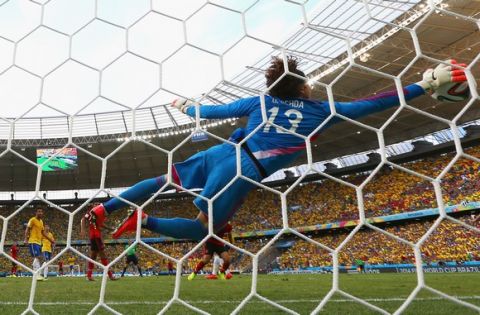 FORTALEZA, BRAZIL - JUNE 17: Guillermo Ochoa of Mexico dives to make a save during the 2014 FIFA World Cup Brazil Group A match between Brazil and Mexico at Castelao on June 17, 2014 in Fortaleza, Brazil.  (Photo by Robert Cianflone/Getty Images)