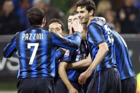 Inter Milan defender Andrea Ranocchia, right, celebrates with his teammates Yuto Nagatomo, second left, of Japan, and Giampaolo Pazzini, left, and Houssine Kharja, third right, of France, after scoring during the Serie A soccer match between Inter Milan and Cagliari at the San Siro stadium in Milan, Italy, Saturday, Feb. 19, 2011. (AP Photo/Antonio Calanni)