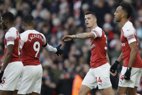 Arsenal's Granit Xhaka, second from right, celebrates after scoring his side's first goal during the English Premier League soccer match between Arsenal and Fulham at Emirates stadium in London, Tuesday, Jan. 1, 2019. (AP Photo/Kirsty Wigglesworth)