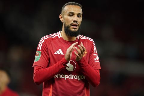 Manchester United's Noussair Mazraoui celebrates with supporters after winning the English League Cup soccer match between Manchester United and Barnsley at Old Trafford, Manchester, England, Tuesday, Sept. 17, 2024. (AP Photo/Dave Thompson)