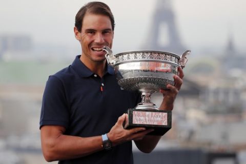 Spain's Rafael Nadal poses with his trophy during a photo call on the rooftop of Galeries Lafayette, Monday, Oct. 12, 2020, after winning the final match of the French Open tennis tournament against Serbia's Novak Djokovic in three sets, 6-0, 6-2, 7-5 at the Roland Garros stadium. (AP Photo/Francois Mori)