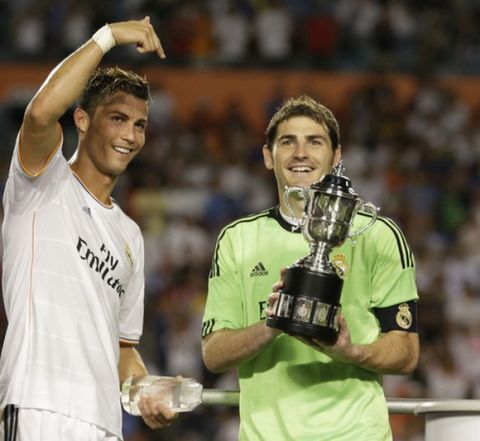 Real Madrid forward Cristiano Ronaldo, left, gestures toward goalkeeper Iker Casillas, who holds the Guinness International Champions Cup after Real Madrid defeated Chelsea 3-1 in a soccer match, Wednesday, Aug. 7, 2013, in Miami Gardens, Fla. Ronaldo holds the Man of the Match trophy. (AP Photo/Wilfredo Lee)