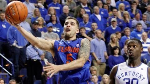 <p>Florida's Scottie Wilbekin (5) shoots near Kentucky's Julius Randle (30) during the second half of an NCAA college basketball game on Saturday, Feb. 15, 2014, in Lexington, Ky. Florida won 69-59. (AP Photo/James Crisp)</p>
