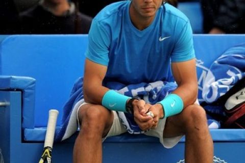 LONDON, ENGLAND - JUNE 10:  Rafael Nadal of Spain sits on the sidelines as rain delays play during his Men's Singles quarter final match against Jo-Wilfred Tsonga of France on day five of the AEGON Championships at Queens Club on June 10, 2011 in London, England.  (Photo by Michael Regan/Getty Images)