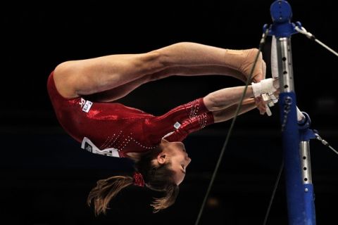 TOKYO, JAPAN - OCTOBER 08:  Victoria Komova of Russia competes on the Uneven Bars aparatus in the Women's qualification during day two of the Artistic Gymnastics World Championships Tokyo 2011 at Tokyo Metropolitan Gymnasium on October 8, 2011 in Tokyo, Japan.  (Photo by Adam Pretty/Getty Images)