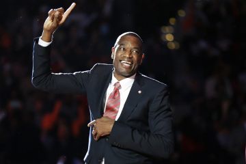 Former Atlanta Hawks' Dikembe Mutombo reacts upon seeing his retired jersey number raised to the rafters during a ceremony at halftime of an NBA basketball game between the Hawks and the Boston Celtics on Tuesday, Nov. 24, 2015, in Atlanta. (AP Photo/David Goldman)