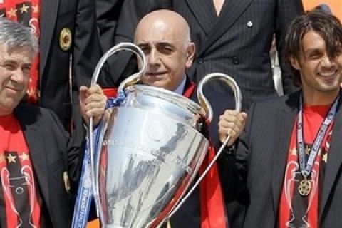 From left: AC Milan coach Carlo Ancelotti, vice-president Adriano Galliani and defender Paolo Maldini hold the Champions League trophy upon landing at the Milan Malpensa airport, Italy, Thursday, May 24, 2007. AC Milan beat Liverpool 2-1 in the final soccer match of the Champions League, at the Athens Olympic stadium, Wednesday. (AP Photo/Antonio Calanni)