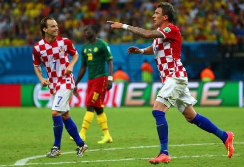 MANAUS, BRAZIL - JUNE 18: Mario Mandzukic of Croatia (R) celebrates scoring his team's third goal with Ivan Rakitic during the 2014 FIFA World Cup Brazil Group A match between Cameroon and Croatia at Arena Amazonia on June 18, 2014 in Manaus, Brazil.  (Photo by Clive Brunskill/Getty Images)