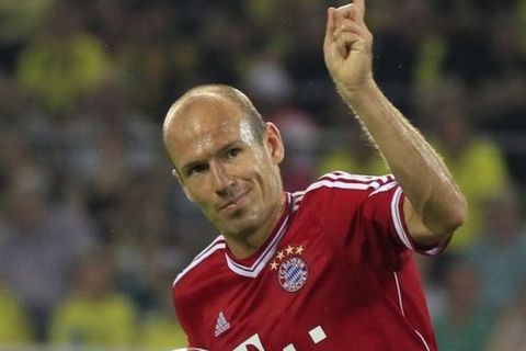 Bayern's Arjen Robben of the Netherlands celebrates after scoring  during the Supercup final soccer match between BvB Borussia Dortmund  and Bayern Munich in Dortmund, Germany, Saturday, July 27, 2013. (AP Photo/Frank Augstein)