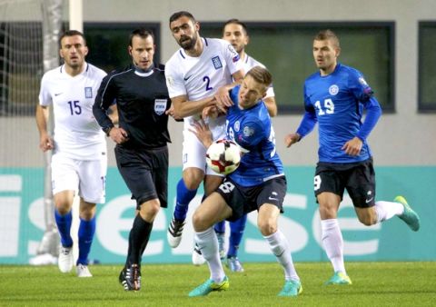 Greece's Ioannis Manniatis, center left, and Estonia's Karol Mets struggle for a ball during their World Cup Group H qualifying soccer match between Estonia and Greece in Tallinn, Estonia, on Tuesday, March 29, 2016. (AP Photo/Liis Treimann)