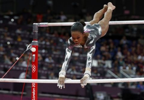 US gymnast Gabrielle Douglas performs during the women's uneven bars of the artistic gymnastics event of the London Olympic Games on August 6, 2012 at the 02 North Greenwich Arena in London.  Russia's gymnast Aliya Mustafina  won gold, China's He Kexin took silver and Britain's Beth Tweddle got bronze.     AFP PHOTO / THOMAS COEX        (Photo credit should read THOMAS COEX/AFP/GettyImages)