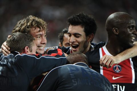 Paris' French defender Christophe Jallet (unseen) is congratulated by his teammate Argentinan midfielder Javier Pastore (C) after he scored a goal during the French L1 football match Paris vs. Lyon on October 2, 2011 at the Parc des Princes in Paris. AFP PHOTO / FRED DUFOUR (Photo credit should read FRED DUFOUR/AFP/Getty Images)