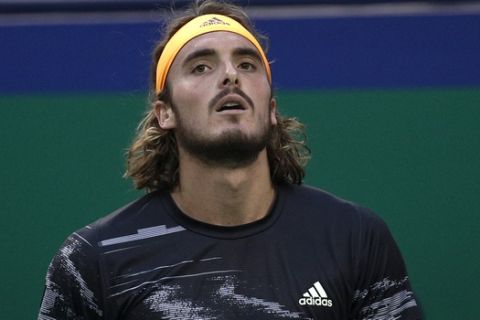 Stefanos Tsitsipas of Greece reacts as he plays against Daniil Medvedev of Russia in their men's singles semifinals match at the Shanghai Masters tennis tournament at Qizhong Forest Sports City Tennis Center in Shanghai, China, Saturday, Oct. 12, 2019. (AP Photo/Andy Wong)