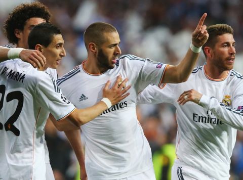 MADRID, SPAIN - APRIL 23:  Karim Benzema of Real Madrid celebrates scoring the opening goal with team mates during the UEFA Champions League semi-final first leg match between Real Madrid and FC Bayern Muenchen at the Estadio Santiago Bernabeu on April 23, 2014 in Madrid, Spain.  (Photo by Martin Rose/Bongarts/Getty Images)