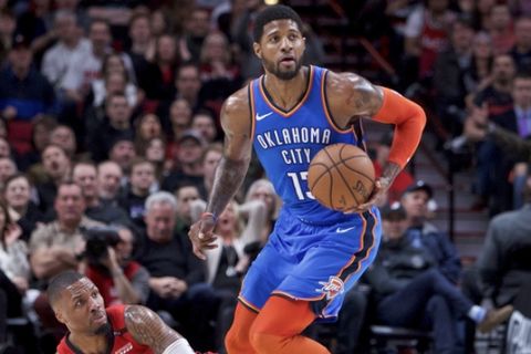 Oklahoma City Thunder forward Paul George, right, dribbles away from Portland Trail Blazers guard Damian Lillard during the first half of an NBA basketball game in Portland, Ore., Friday, Jan. 4, 2019. (AP Photo/Craig Mitchelldyer)