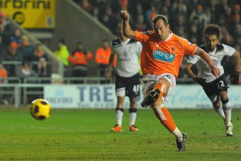 Blackpool's Scottish midfielder Charlie Adam (C) opens the scoring from a penalty during the English Premier League football match agaisnt Tottenham at Bloomfield Road in Blackpool, north-west England on February 22, 2011. AFP PHOTO/ANDREW YATES --- RESTRICTED TO EDITORIAL USE Additional licence required for any commercial/promotional use or use on TV or internet (except identical online version of newspaper) of Premier League/Football League photos. Tel DataCo +44 207 2981656. Do not alter/modify photo (Photo credit should read ANDREW YATES/AFP/Getty Images)