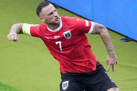 Austria's Marko Arnautovic celebrates after scoring his side's third goal from the penalty spot during a Group D match between Poland and Austria at the Euro 2024 soccer tournament in Berlin, Germany, Friday, June 21, 2024. (AP Photo/Petr Josek)