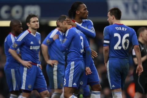 Chelsea's Ashley Cole (C) is comforted by Didier Drogba (2nd R) after he missed a penalty against Everton when the game went to penalties during their FA Cup soccer match at Stamford Bridge in London, February 19, 2011.    REUTERS/Eddie Keogh   (BRITAIN - Tags: SPORT SOCCER IMAGES OF THE DAY)