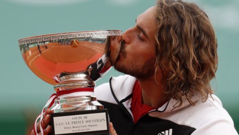 Stefanos Tsitsipas of Greece kisses the trophy after defeating Andrey Rublev of Russia in the Monte Carlo Tennis Masters tournament finals in Monaco, Sunday, April 18, 2021. (AP Photo/Jean-Francois Badias)