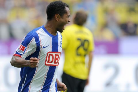 RESTRICTIONS / EMBARGO - DFL LIMITS THE USE OF IMAGES ON THE INTERNET TO 15 PICTURES (NO VIDEO-LIKE SEQUENCES) DURING THE MATCH AND PROHIBITS MOBILE (MMS) USE DURING AND FOR FURTHER TWO HOURS AFTER THE MATCH. FOR MORE INFORMATION CONTACT DFL. 
Herta Berlin's forward Raffael celebrates after his goal  during the German first division Bundesliga football match Borussia Dortmund vs Hertha BSC in the western German city of Dortmund on September 10, 2011. AFP PHOTO / PATRIK STOLLARZ (Photo credit should read PATRIK STOLLARZ/AFP/Getty Images)