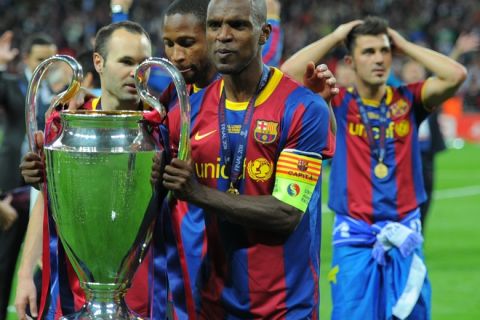 Barcelona's French defender Eric Abidal celebrates with the trophy at the end of the UEFA Champions League final football match FC Barcelona vs. Manchester United, on May 28, 2011 at Wembley stadium in London.Barcelona won 3 to 1. AFP PHOTO / LLUIS GENE (Photo credit should read LLUIS GENE/AFP/Getty Images)