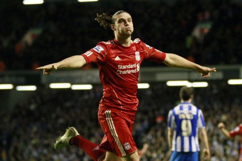 Liverpool's Andy Carroll celebrates after scoring a goal against Brighton and Hove Albion during their English FA Cup fifth round soccer match at Anfield, Liverpool, England, Sunday Feb. 19, 2012. (AP Photo/Tim Hales)