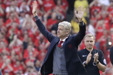 Arsenal's French manager Arsene Wenger waves before the English Premier League soccer match between Arsenal and Burnley at the Emirates Stadium in London, Sunday, May 6, 2018. The match is Arsenal manager Arsene Wenger's last home game in charge after announcing in April he will stand down as Arsenal coach at the end of the season after nearly 22 years at the helm. (AP Photo/Matt Dunham)