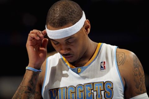 DENVER, CO - FEBRUARY 10:  Carmelo Anthony #15 of the Denver Nuggets looks on during a break in the action against the Dallas Mavericks during NBA action at the Pepsi Center on February 10, 2011 in Denver, Colorado. The Nuggets defeated the Mavericks 121-120. NOTE TO USER: User expressly acknowledges and agrees that, by downloading and or using this photograph, User is consenting to the terms and conditions of the Getty Images License Agreement.  (Photo by Doug Pensinger/Getty Images)