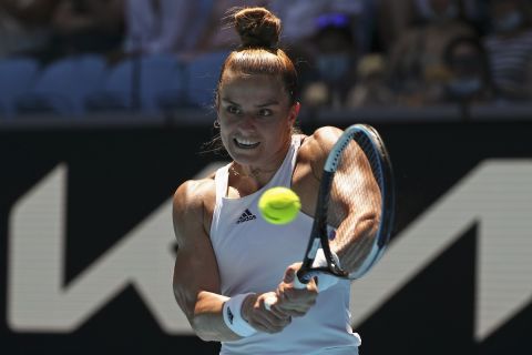 Maria Sakkari of Greece makes a backhand return to Jessica Pegula of the U.S. during their fourth round match at the Australian Open tennis championships in Melbourne, Australia, Sunday, Jan. 23, 2022. (AP Photo/Tertius Pickard)