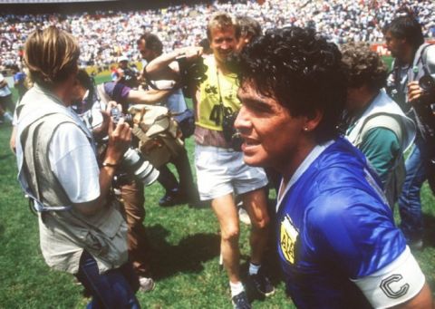 Argentina captain Diego Maradona is surrounded by photographers after captaining his side to a 2-1 victory over England in the 1986 World Cup Finals quarter final match.