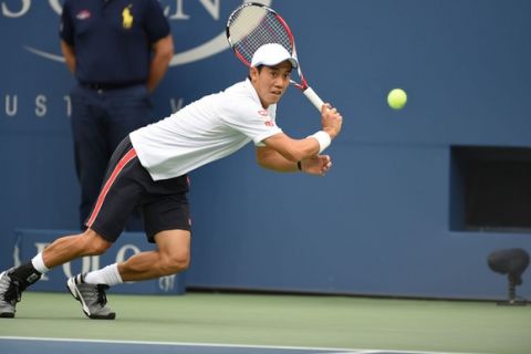 No. 10 seed Kei Nishikori in action against No. 14 seed Marin Cilic during the 2014 US Open Men's Championship match.