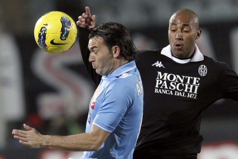 Napoli's Salvatore Aronica (L) heads the ball past Siena's Brazilian striker Ferreira Da Silva Reginaldo during the first leg of their Coppa Italia semi-final at Artemio Franchi stadium in Siena on February 9, 2012.  AFP PHOTO / FABIO MUZZI (Photo credit should read FABIO MUZZI/AFP/Getty Images)