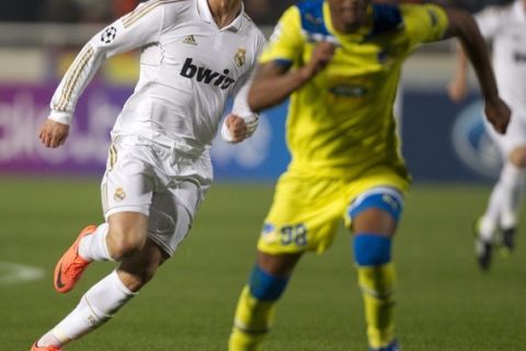 Real Madrid's Portuguese forward Cristiano Ronaldo (L) challenges Apoel's Brazilian defender William Boaventura (R) during the UEFA Champions League first leg quarter-final football match between Apoel FC and Real Madrid at the GSP Stadium in the Cypriot capital Nicosia on March 27, 2012.  Real Madrid won 3-0. AFP PHOTO / JACK GUEZ (Photo credit should read JACK GUEZ/AFP/Getty Images)