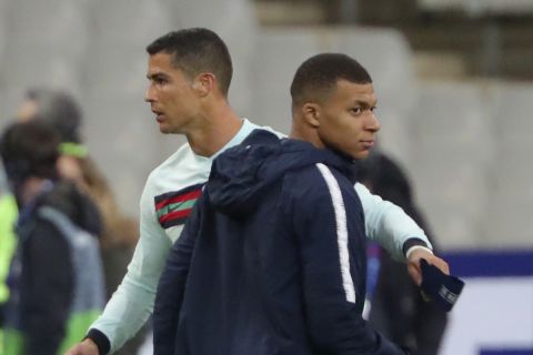 France's Kylian Mbappe and Portugal's Cristiano Ronaldo, left, greet each other at the end of the UEFA Nations League soccer match between France and Portugal at the Stade de France in Saint-Denis, north of Paris, France, Sunday, Oct. 11, 2020. (AP Photo/Thibault Camus)