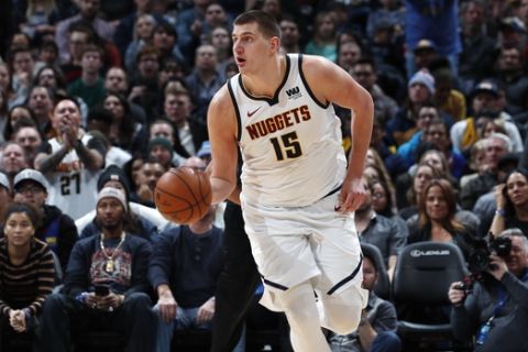 FILE - In this Tuesday, Jan. 1, 2019, file photo, Denver Nuggets center Nikola Jokic picks up a loose ball and heads down the court in the second half of an NBA basketball game against the New York Knicks in Denver. Jokic, a 7-footer from Serbia, is leading the Nuggets to new heights so far this season with his style of play in the pivot. (AP Photo/David Zalubowski, File)