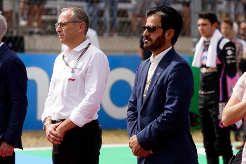 FIA president Mohammed bin Sulayem, right, stands during a tribute for Red Bull team owner Dietrich Mateschitz before the F1 U.S. Grand Prix auto race at Circuit of the Americas, Sunday, Oct. 23, 2022, in Austin, Texas. (AP Photo/Shawn Thew, Pool)